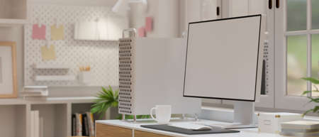Computer monitor with empty screen decorated with computer device, coffee cup in blurred office room interior background, 3D rendering, 3D illustrationの写真素材