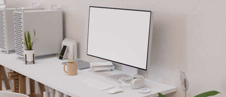 Desktop computer with blank empty screen in modern work space designed with headphone, device and...