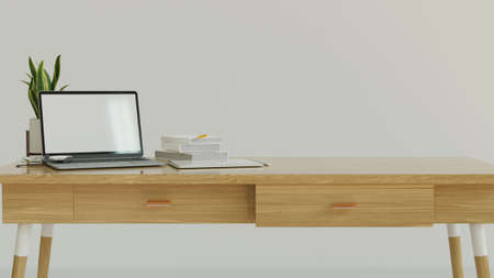 Comfortable work space designed with white wall, wood table and laptop mock up with blank screen, decor and copy space for product display on top, 3d rendering, 3d illustrationの写真素材