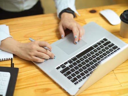 Business female hands using laptop, working on laptop, searching informations, browsing idea on website, close upの写真素材