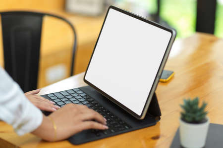 Female surfing some business information via tablet, tablet with blank empty screenの写真素材