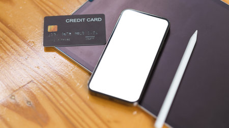 Smartphone mock up blank screen with credit card on wooden table, Cashless society, Online payment conceptの写真素材