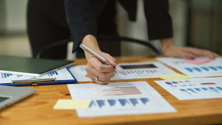 Close up business female hands signing documents on table at office, financial managementの写真素材