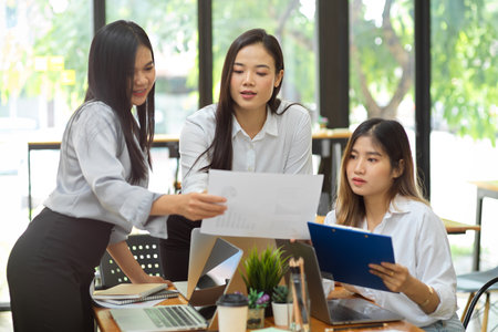 Business team look at the report together, teamwork, business worker at officeの写真素材