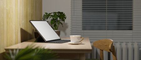 Side view, cozy home office interior in living room, digital tablet with keyboard and coffee cup on wood table, overhead light, work at night, 3d rendering, 3d illustrationの写真素材