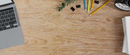 Copy space on wooden study table with laptop, stationery, student workspace concept, background for presentation, 3d rendering, 3d illustrationの写真素材