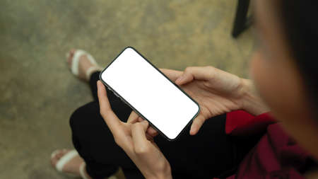 Top view, female messaging to her friends, smartphone with blank screen, social networkの写真素材