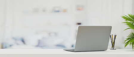 Laptop computer on modern top table with copy space for your product, blurred living room in background, 3d rendering, 3d illustrationの写真素材
