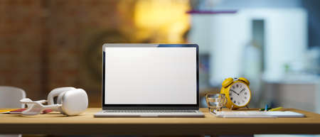 Close up of empty laptop mockup, tablet, headphone, clock on wood counter table, blurred kitchen room in the background, 3d rendering, 3d illustrationの写真素材