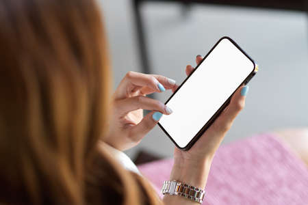 Top view, close up, female searching website, download application via mobile phone, smartphone mockup, blank screenの写真素材
