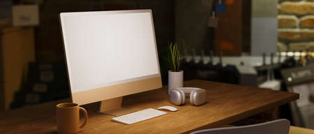 Side view, Vintage wood table with electronic devices, computer mockup, headphone, keyboard, mouse and decor, stone wall in blur background, 3d rendering, 3d illustrationの写真素材