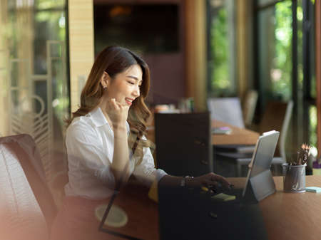 Excited and success businesswoman, celebrate for great result work project  on laptop at office, gold achievementの写真素材
