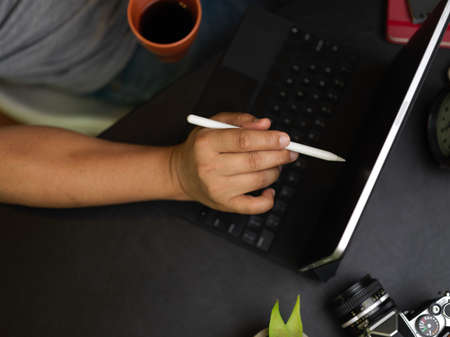 Flat lay, businessman work from home at weekend, working on tablet while drinking coffee in the...