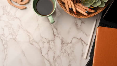 Copy space on marble background corner border with tablet, stationery, book, coffee, modern...
