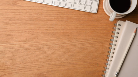 Wood office desk with office stuff, computer keyboard, notebook, pencil, black coffee and copy blank space, top view, flat lay, background for presentationの写真素材