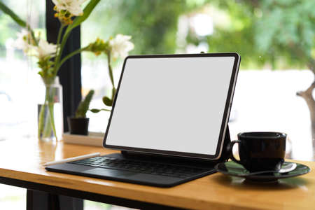 Digital tablet computer mockup, working space with wireless device, blurred backgroundの写真素材