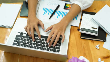 Top view, female hands typing on laptop keyboard computer, office worker, financial worker, businesspeopleの写真素材