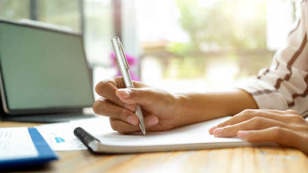Side view, female business student take lecture during learning on online class via portable tabletの写真素材