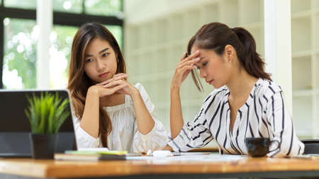 Two businesswoman serious about managing their work, concern about business plan at officeの写真素材