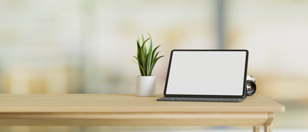 Tablet computer blank screen mockup stand on wood table with copy space and small plant in pot, blurred background, 3d rendering, 3d illustrationの写真素材