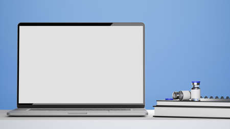 Laptop blank screen mockup, vaccine bottles, medical books on doctor or pharmacist office desk, blue background, 3d rendering, 3d illustrationの写真素材
