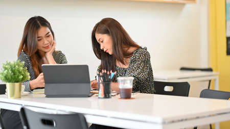 Businesswomen discussing project results and planning work in meeting room, teamwork, brainstormingの写真素材