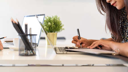 Business female writing, taking notes on notebook, office working spaceの写真素材