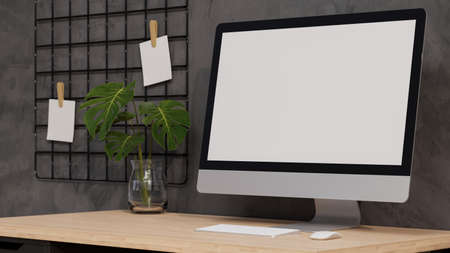 Close up, Desktop computer blank screen mockup on wooden table with monstera leaf in vase, grid memo board on grey wall in modern loft interior style, 3d rendering, 3d illustrationの写真素材
