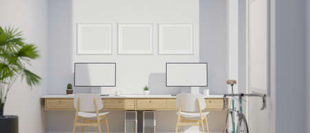 Modern office studio interior design with two desktop computer mockup, poster frame mockup on wall interior, modern decoration, 3d rendering, 3d illustrationの写真素材