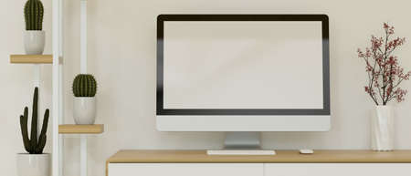 Modern comfortable workspace in Scandinavia interior style with computer blank screen mockup on wooden desk with cactus shelf, close up, 3d rendering, 3d illustrationの写真素材