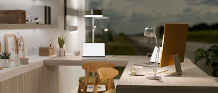Modern workplace in stylish house with two laptop mockup and computer on wooden desk with blurred background, 3d rendering, 3d illustrationの写真素材