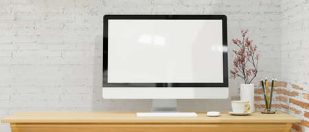 Simple workspace with modern desktop computer mockup in white brick wall decoration, coffee cup, pencils, flower in vase on wooden desk, 3d rendering, 3d illustrationの写真素材