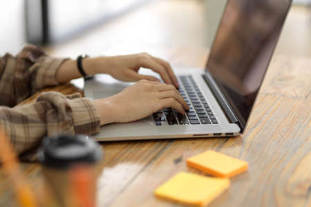 Hipster female college student do homework on laptop computer, typing on laptop keyboard, female...