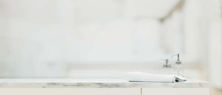 Free space on marble top table with towel and shampoo or soap bottles in blurry bright bathroom background, Shower background concept, 3d rendering, 3d illustrationの写真素材