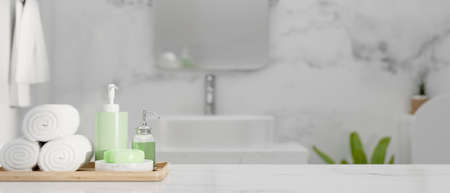 Closeup of marble countertop with space for montage product and set of bathing over stylish marble bathroom in apartment or hotel background, 3d rendering, 3d illustrationの写真素材