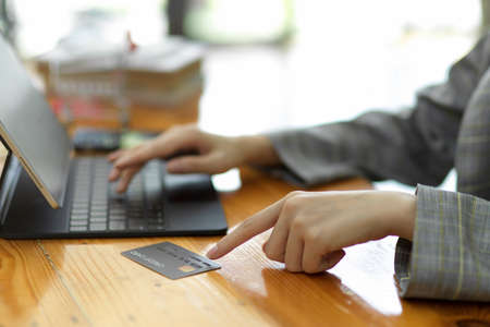 Businesswoman with credit card concept. female making online payment via portable tablet. e-commerce, internet banking, online serviceの写真素材