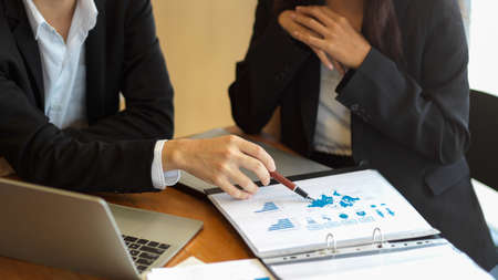 Cropped shot of financial team discuss and analyse business financial data together in office with data report filesの写真素材