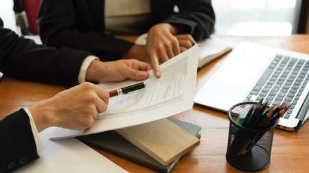 Cropped image of Two of business person look at the document together at office workplaceの写真素材