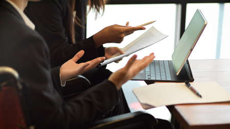 Cropped shot of Two businessman and businesswoman or lawyer discussing works in office, teamwork, brainstormingの写真素材