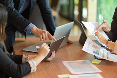 Cropped image of business group consulting and managing business project together in meeting roomの写真素材