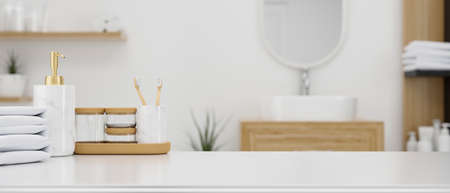 Toiletries, bath containers, and towels on a tabletop, with montage space in the background over a Scandinavian minimalist bathroom interior. 3D illustration, 3D renderingの写真素材