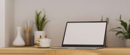 Close-up of Modern portable laptop computer with blank screen mockup stand on wooden worktable with modern decorations. 3d rendering, 3d illustrationの写真素材