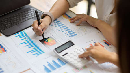 Cropped shot of Business colleagues working on financial reports and calculating business campaign budgets at workplaceの写真素材