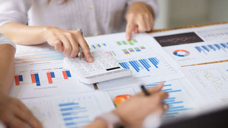 Close-up The financial team consults on the financial data report and plans the next quarter's business investment.の写真素材