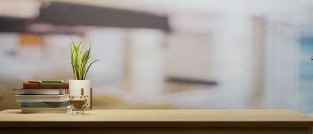 Wooden tabletop with copy space for product display montage, a stack of books, and a houseplant with a blurred living room interior in the background. 3D illustration, 3D renderingの写真素材