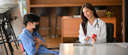 Female doctor diagnose male patient in examination room. Physician consults male patient giving an...