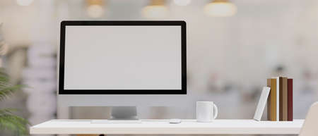 Closeup, Modern desktop computer mockup stand on work table with coffee mug and books over blurred background. 3d rendering, 3d illustrationの写真素材