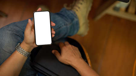 Top view close-up of A hipster male freelancer using his smartphone to checking his work agenda. mobile blank screen mockupの写真素材