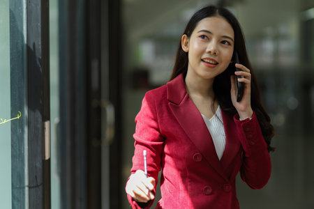 Female business professional making a phone call with business client in the officeの写真素材