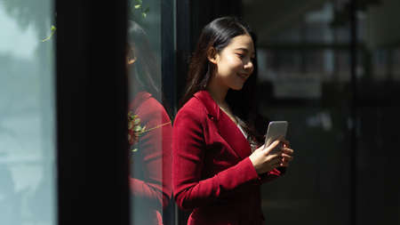 A millennial businesswoman is happy after closing a deal over the phone with new business partners.の写真素材